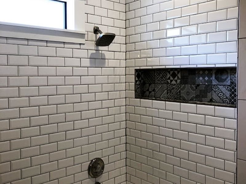 finished remodeled shower with white subway tiles