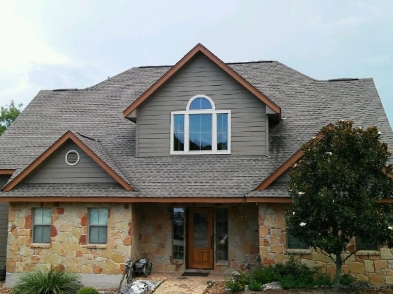 grey painted tan stone house front