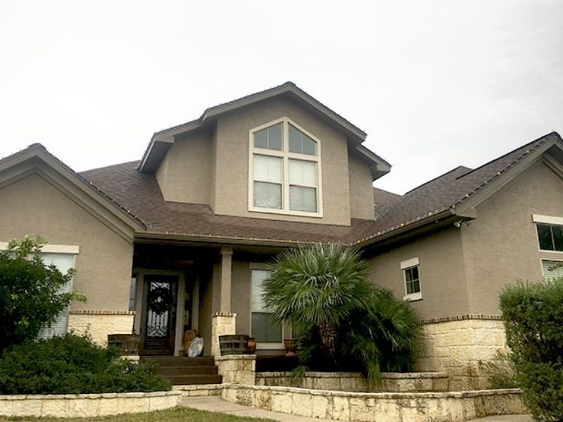 grey painted tan stone house front