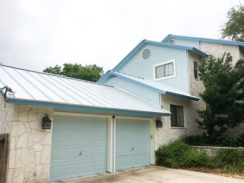 house painted blue side and garage view
