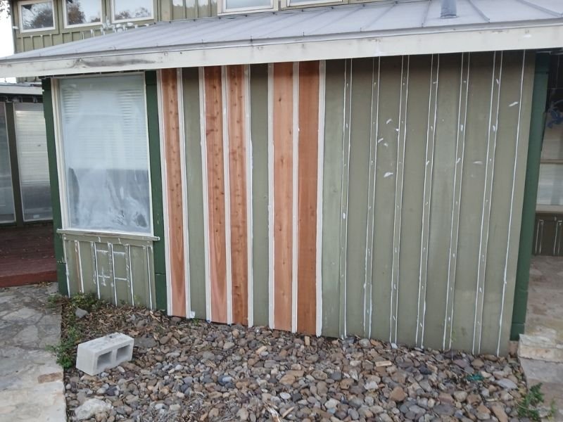 House side with unfinished siding.