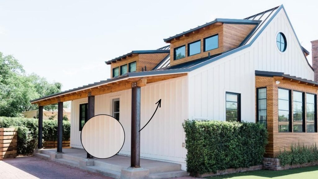 Modern white barn-style house with wood accents and black metal roof