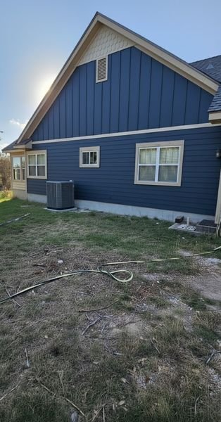 Blue house exterior with painted gable and trim
