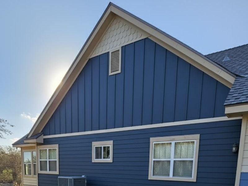 Blue house exterior with painted gable and trim