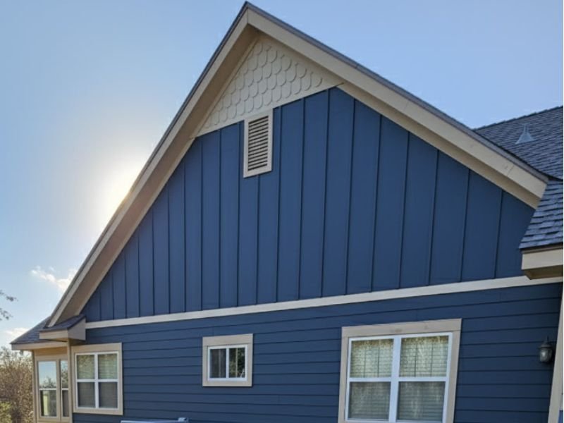 Blue house exterior with painted gable and trim