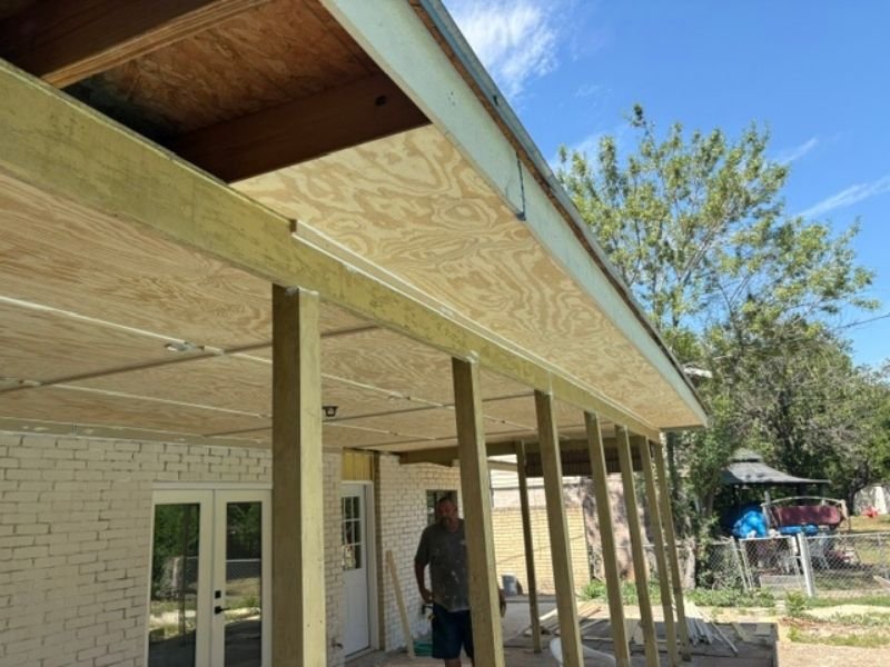 Covered patio ceiling installation with support posts