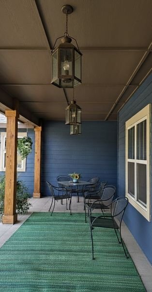 Covered porch with newly painted blue exterior walls