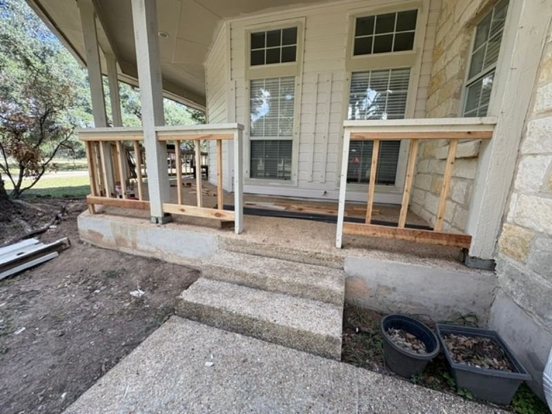 Front porch steps with railing installation in progress